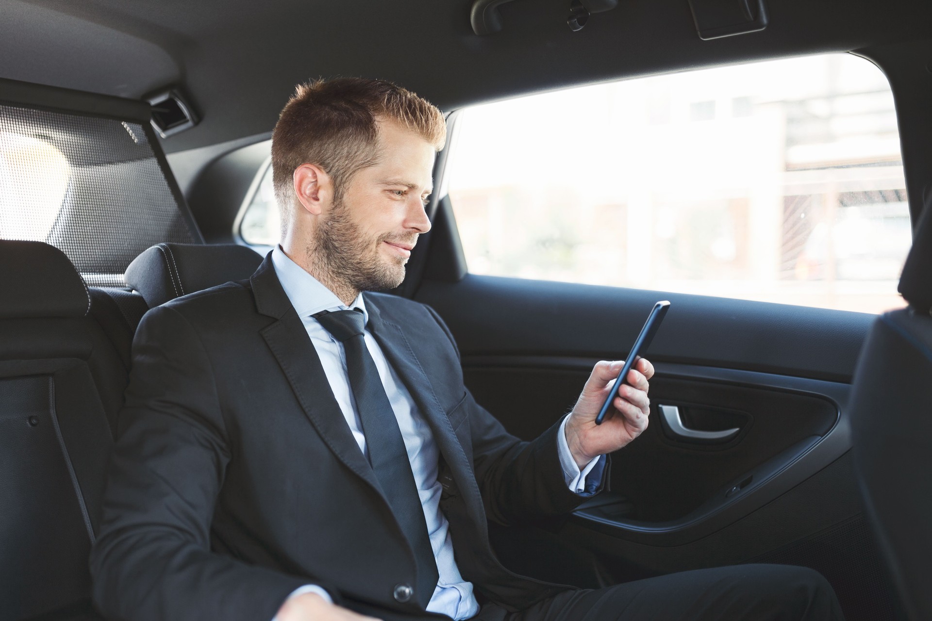 Exekutive Geschäftsmann auf der Rückseite Auto mit dem Handy telefonieren